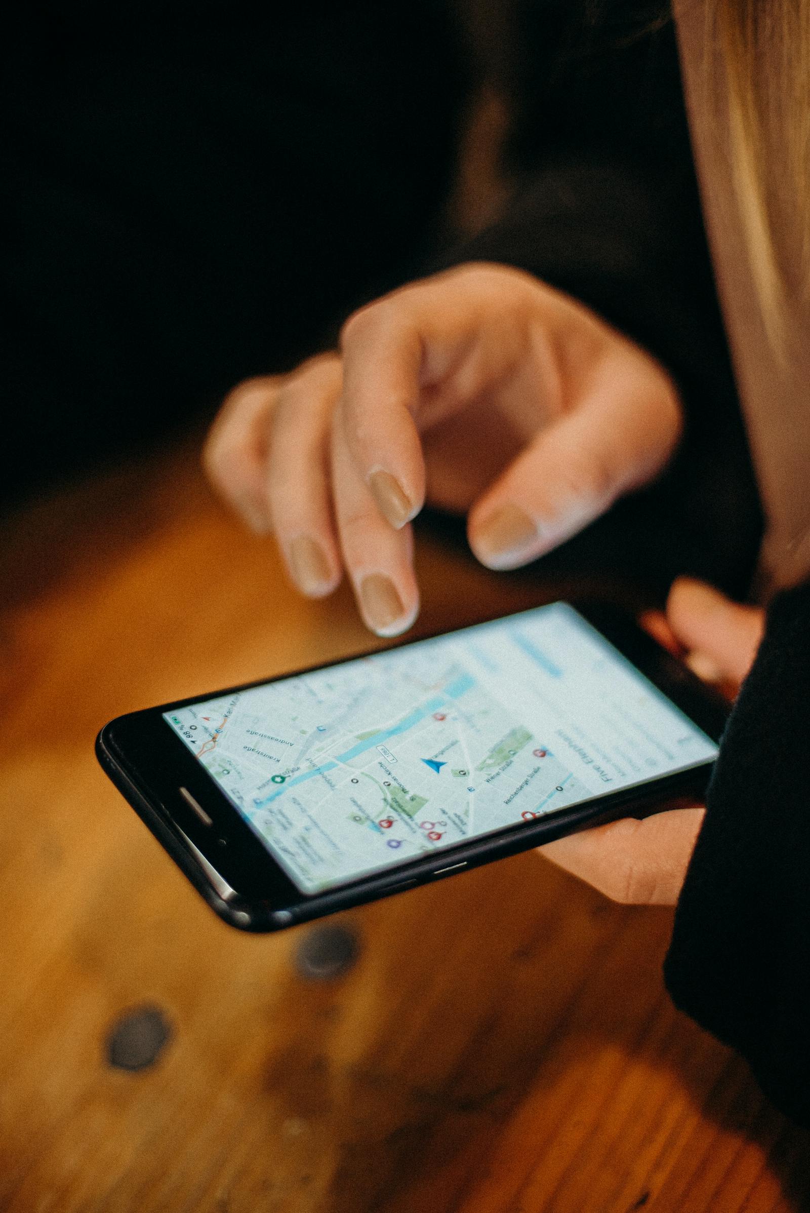 Flutter Navigation Basics: Moving Between Screens Hand holding a smartphone displaying a map application for navigation.
