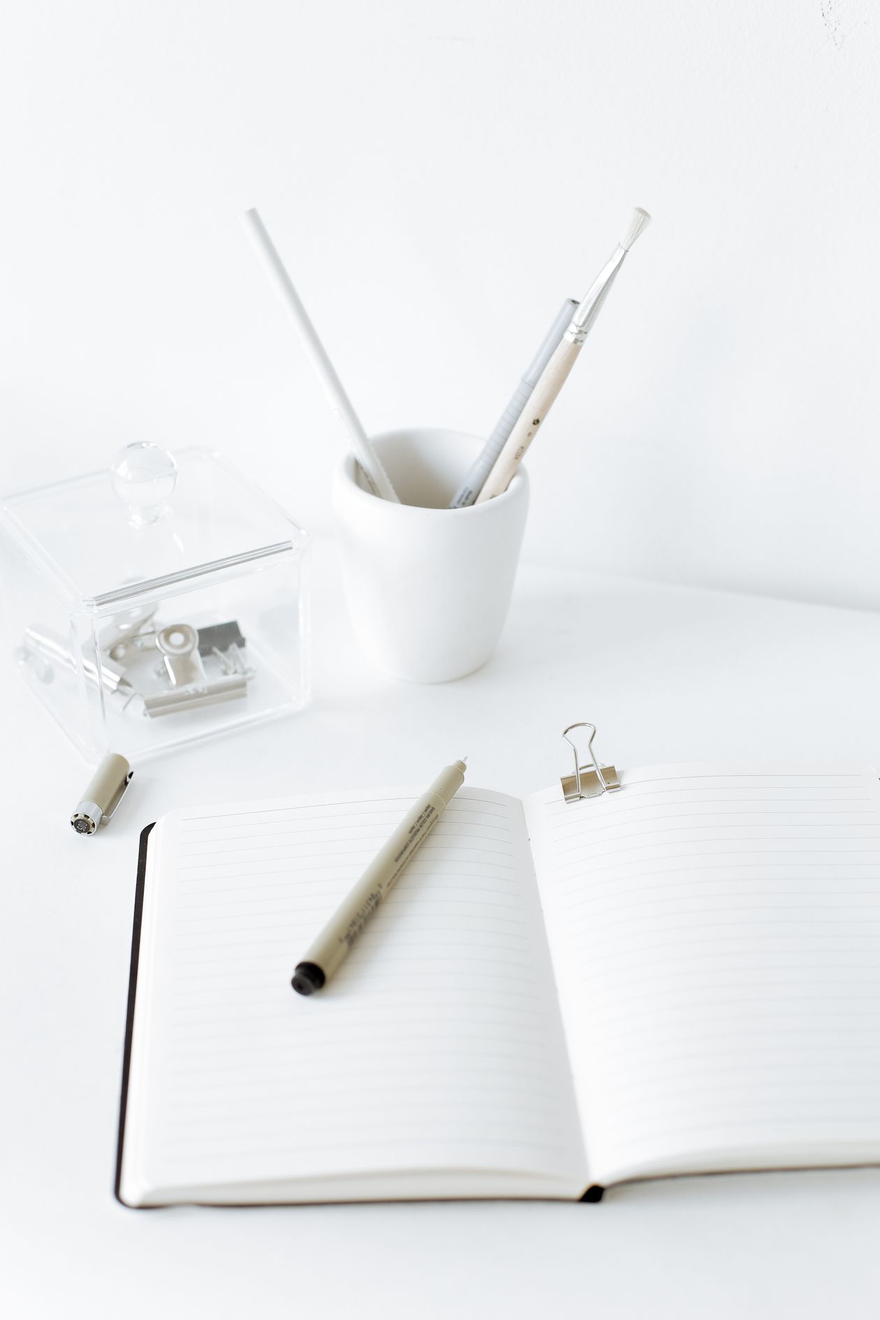Open notebook and pen on a desk for practicing Dart functions
