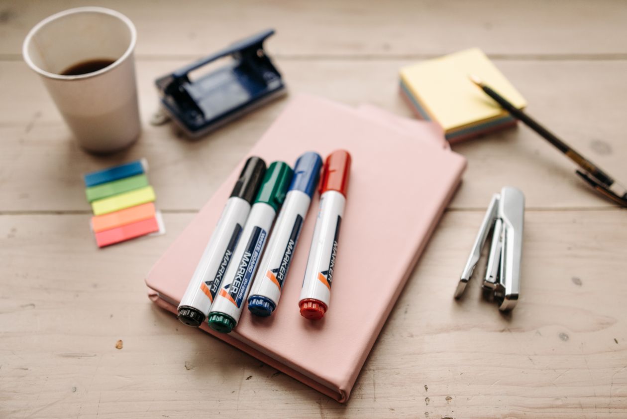 Notebook, sticky notes and pen for planning a class design