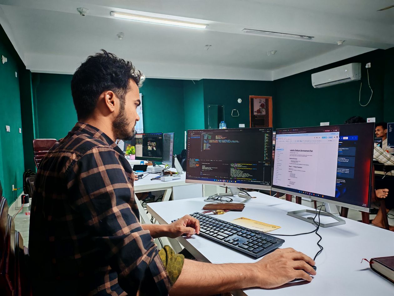Developer at a desk practicing Dart inheritance in an editor